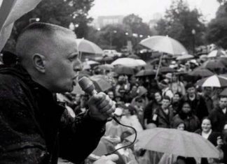 A photo of trans activist Leslie Feinberg addressing a crowd.