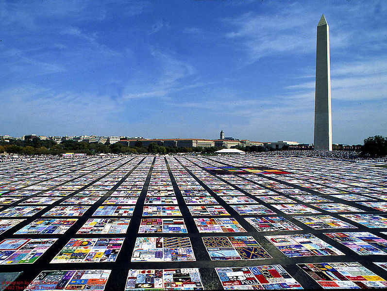 The AIDS Quilt memorial laid out in an open square.