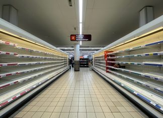 Empty supermarket shelves in a Sainsbury's store.