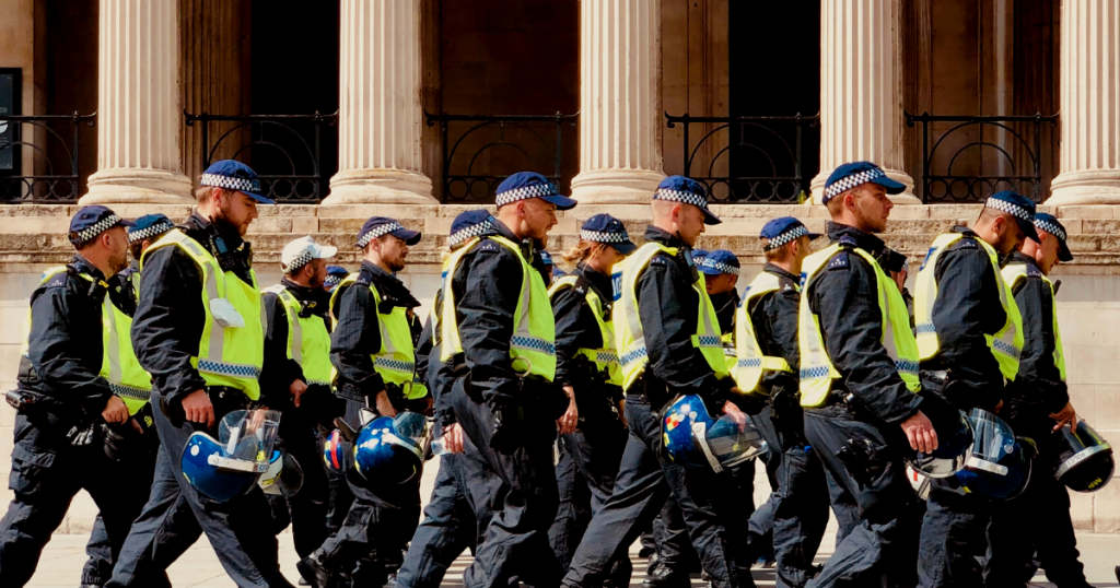 A squad of riot police march past the National Gallery in London.