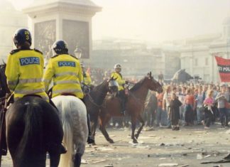 Police on horses facing poll tax protesters, March 1990.
