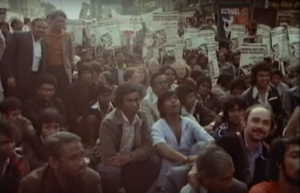 Protestors sit down outside a police station at the Battle for Brick Lane in 1978