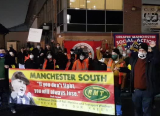 RMT members and supporters pose with banners at a picket in Longsite depot, Manchester.