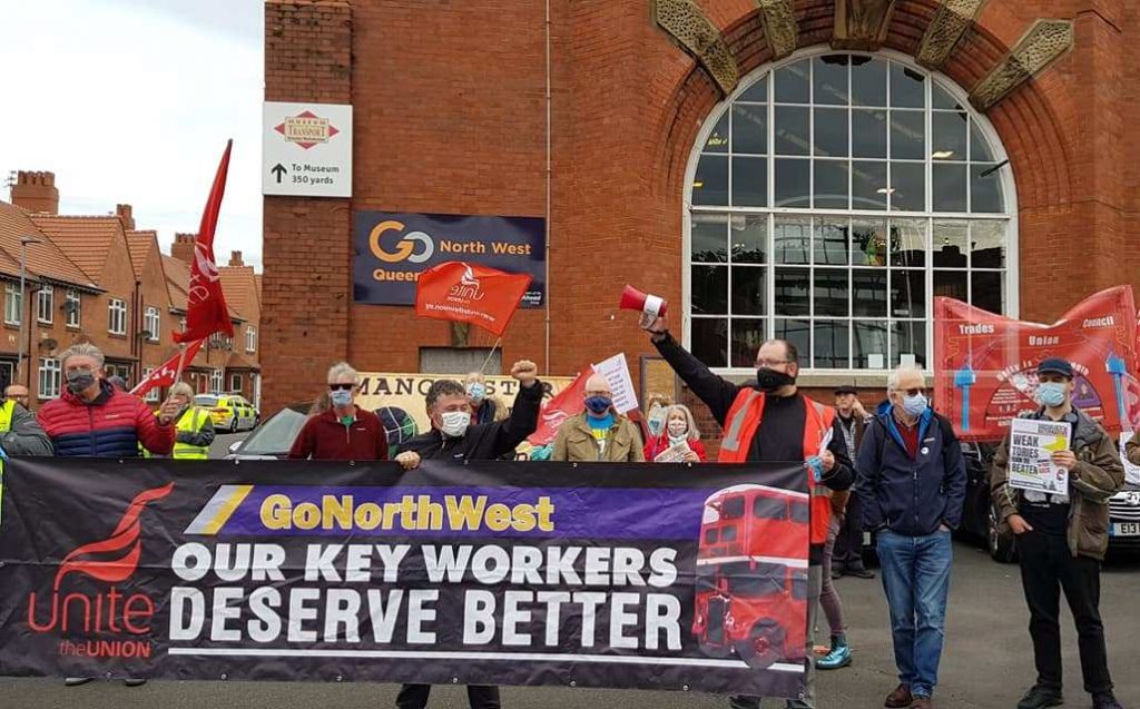 Image shows picketing workers at Go North West with a anner that reads Our Key Workers Deserve Better.