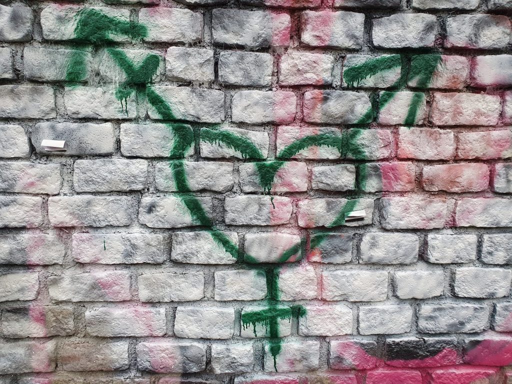 graffiti in Holyrood Park, near the Scottish Parliament showing a heart transgender symbol