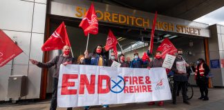 Crowd of strikers with End Fire & Rehire banner