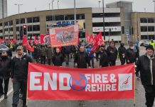 March with banners reading 'end fire & rehire' and 'Unite Queen's Road branch'