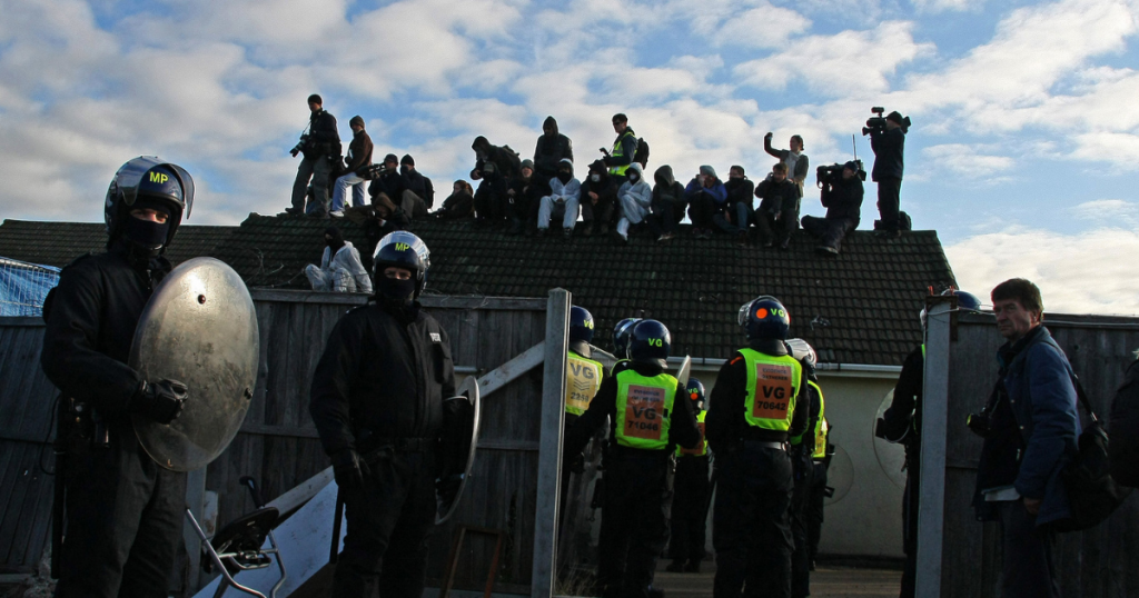 Riot police surround a chalet during the Dale Farm eviction in 2011.