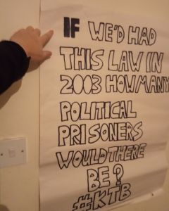 Poster reads "If we'd had this law in 2003 how many political prisoners would there be? #KTB"