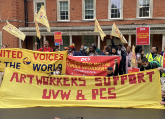 Strikers and supporters in the Royal Parks industrial dispute hold banners and flags representing the unions UVW and PCS, and a large banner that reads 'Art workers support UVW & PCS'