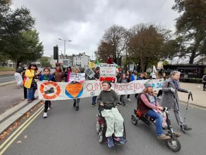 Disabled people in front of wider banner