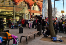 Photo shows protestors rallying round a speaker outside NHS england and Elephant and Castle underground station at the demonstration on 4 December 2021, called by transgender action block.