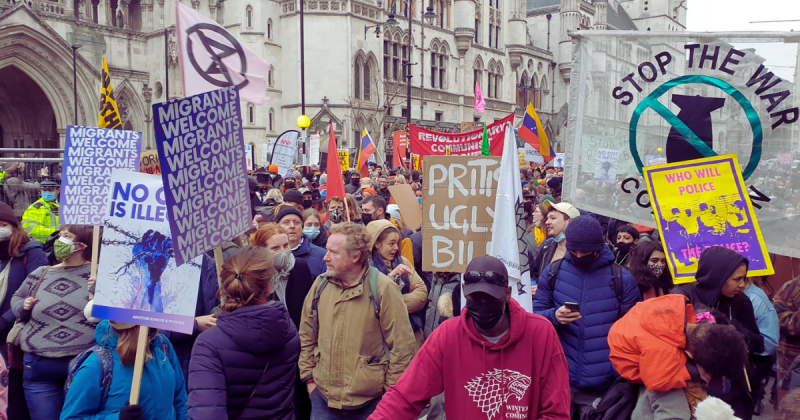 Photo of protestors in the London demonstration as part of the Kill the bill day of action on 15 January 2022. Banners include Stop the War, the Revolutionary Communist Group, Extinction Rebellion, migrants welcome, and homemade placards.