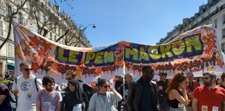 Demonstrators holding a banner which reads ' Le Pen et Macron: le 3eme tour social c'est maintenant! - 'the social 3rd round starts now!'