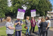 Woem on picket with placards