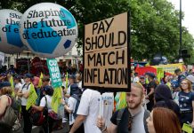 Marchers on TUC protest with "pay should match inflation" placard