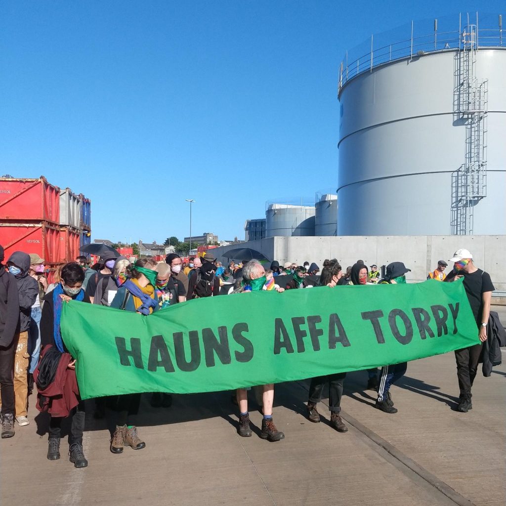 Activists hold banner reading 'Hauns offa Torry'