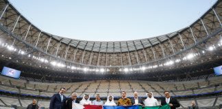 Image shows a row of men standing in the Qatari football stadium, with representatives from Qatar and Jair Bolsonaro.