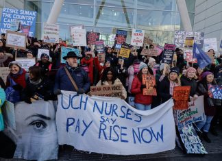 a large picket with a banner reading 'UCH Nurses say Pay Rise Now'.