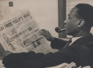 George Padmore reading a newspaper.