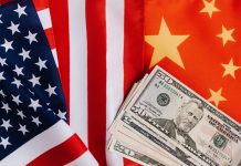 American and Chinese flags and USA dollars