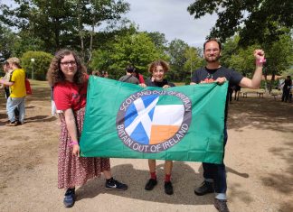 comrades hold a banner reading Scotland out of Britain, Britain out of Ireland.