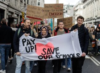 teachers with a banner saying 'Pay Up, Save our schools'